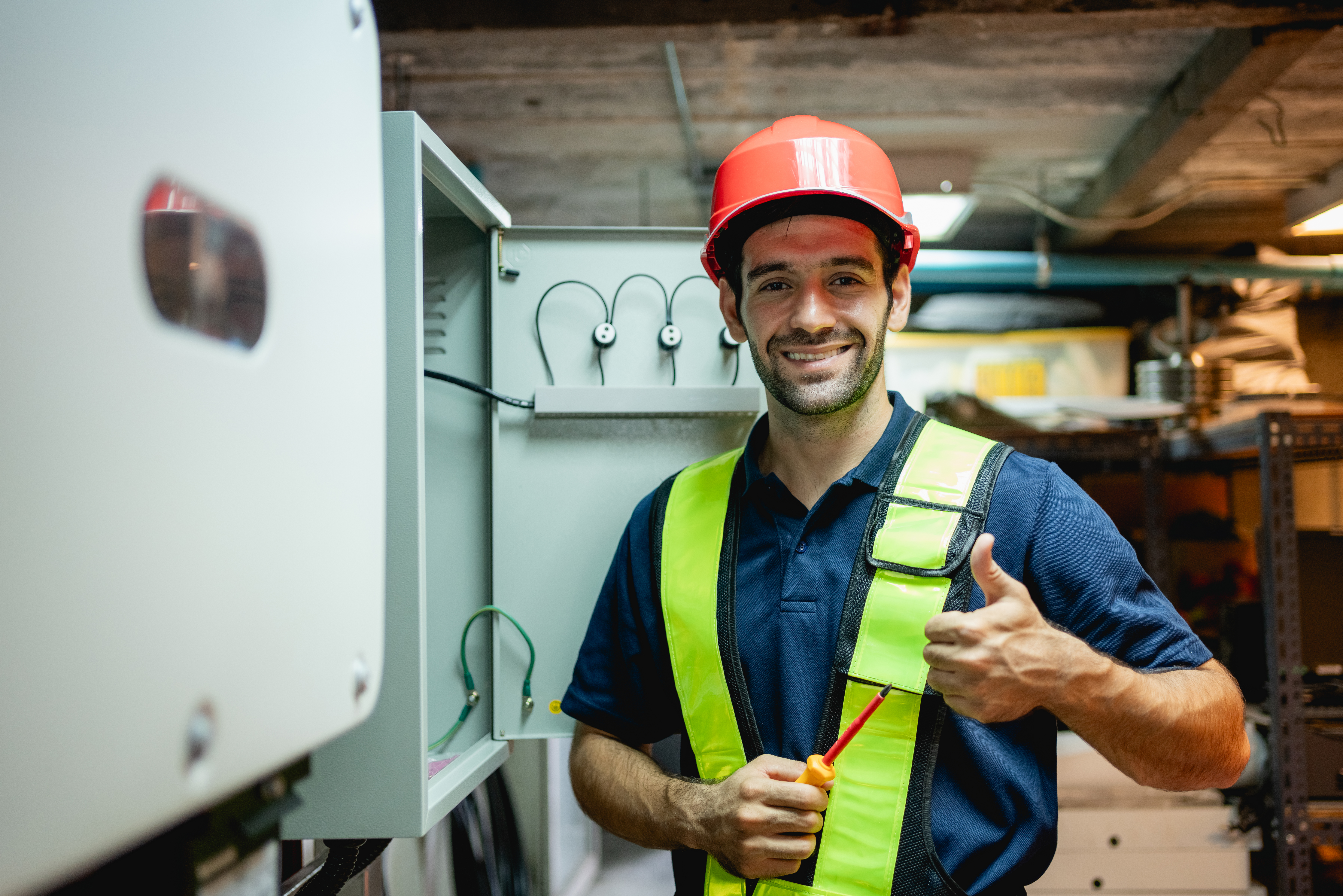Technician Engineering setting inverter solar panel in electrical room. Service engineer installing solar cell on the roof of factory. Clean and Renewable energy concept.