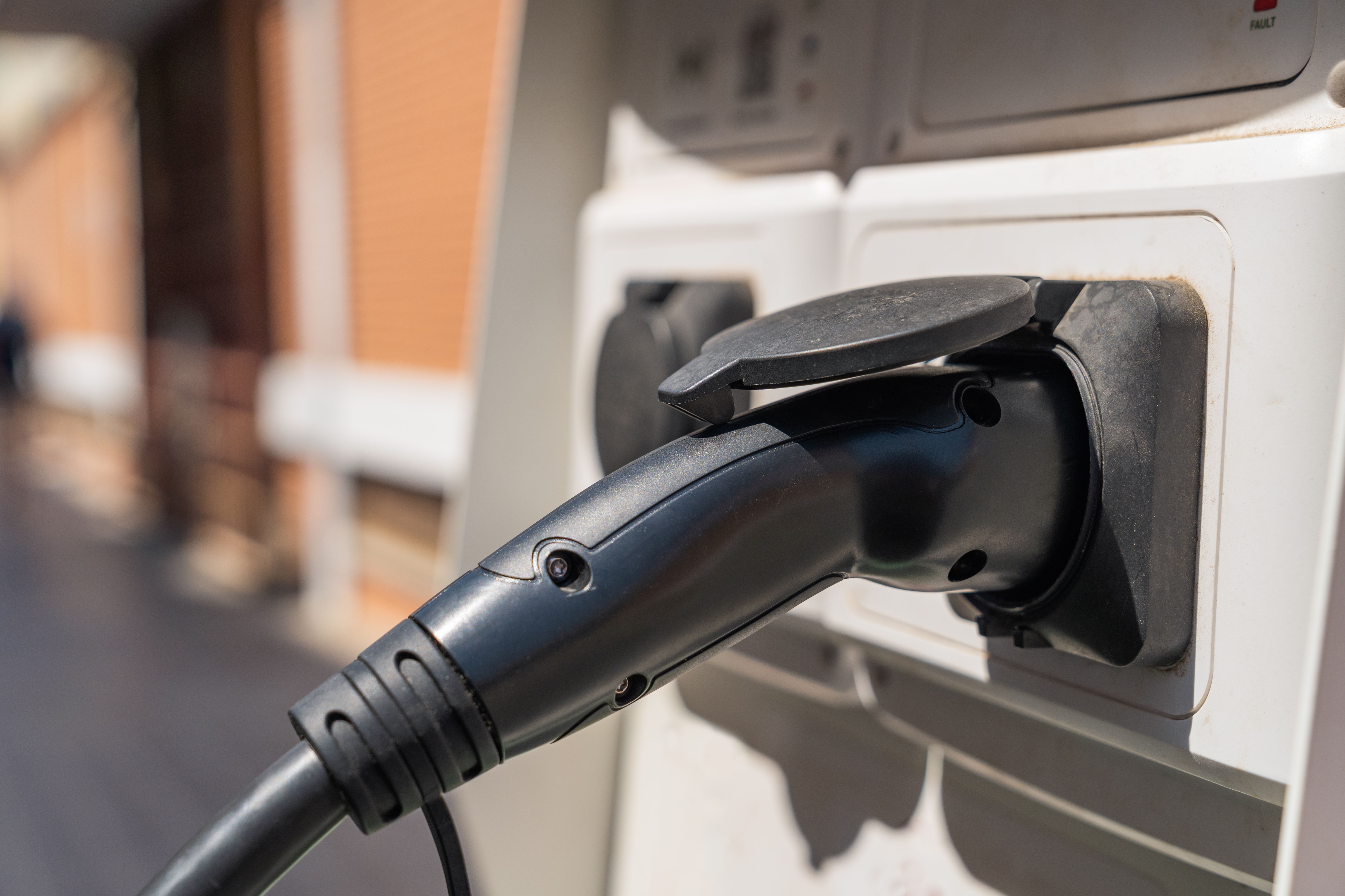 Charging station in the city of Valencia, Spain for electric cars with a connected cable. Close up