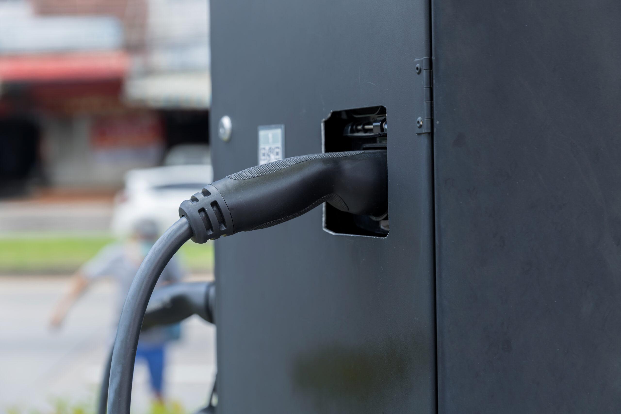 Electric car charging station. Hybrid car Electric charger station in the Car Park. Electric car charging on parking and charging station. Electric socket. Transportation EV