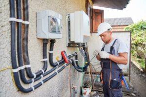 electrician-installing-solar-panel-system-wiring-inverter-and-electric-box