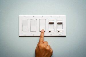 womans-hand-turning-off-the-light