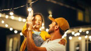 imgi_8_proud-handsome-father-helping-his-little-beautiful-daughter-to-change-a-lightbulb-in-fairy
