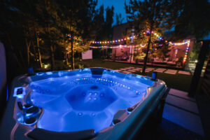 autonomous hot tub or jacuzzi with hot water and evening lighting.